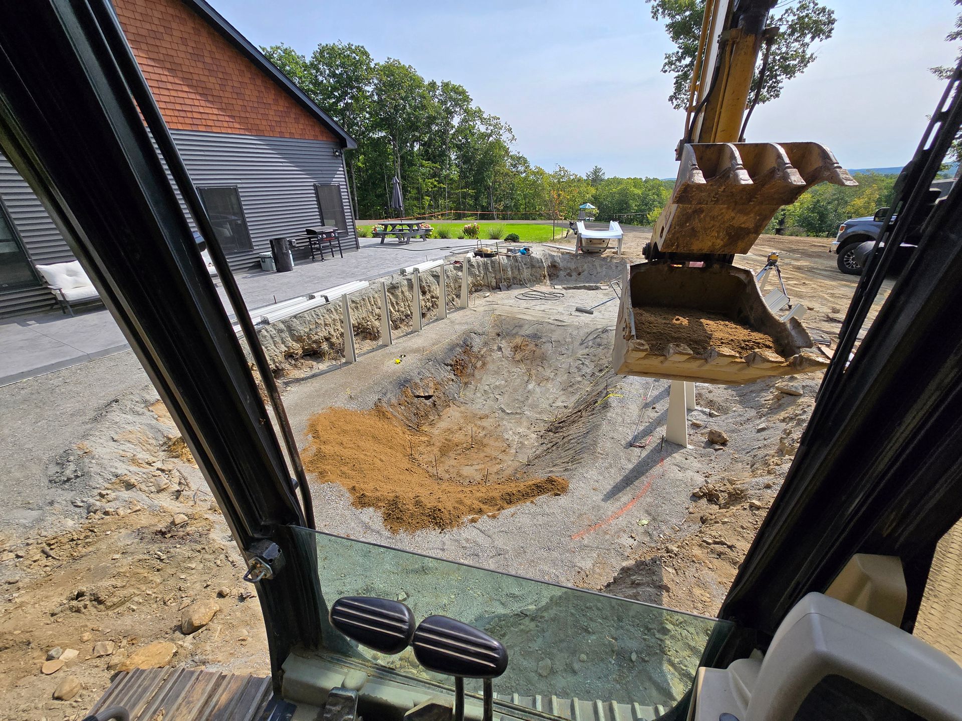 A view of a construction site from inside an excavator.