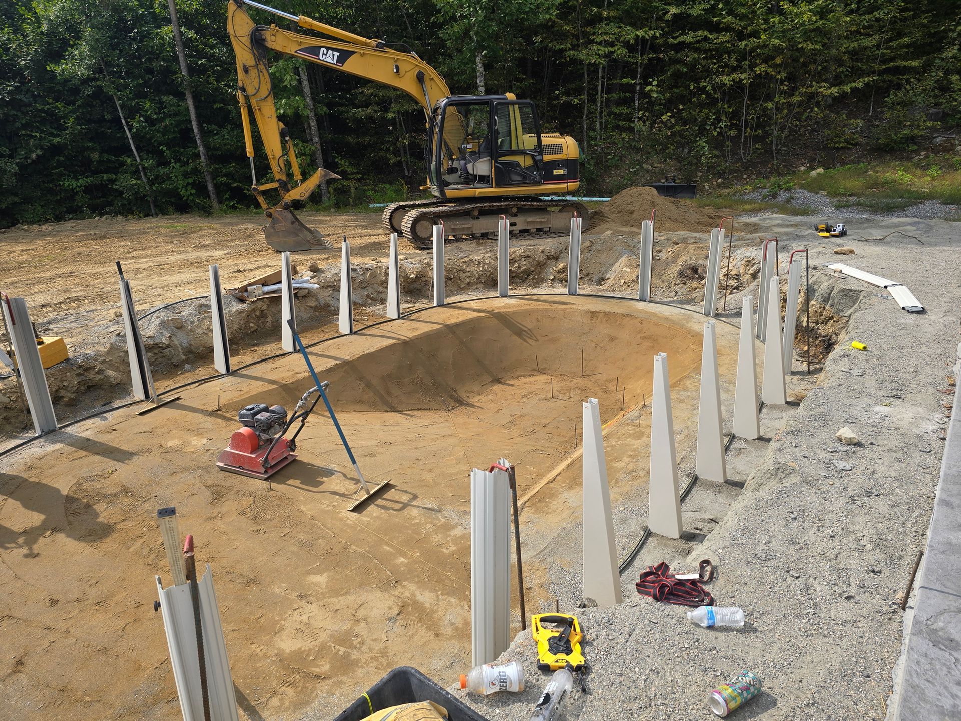 A construction site with a large excavator in the background.