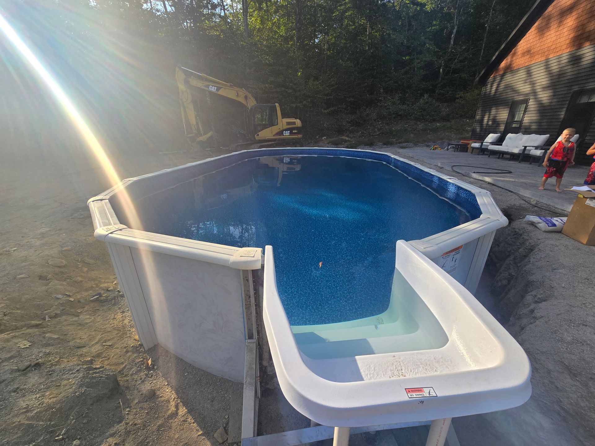 A swimming pool with a slide attached to it is being built.