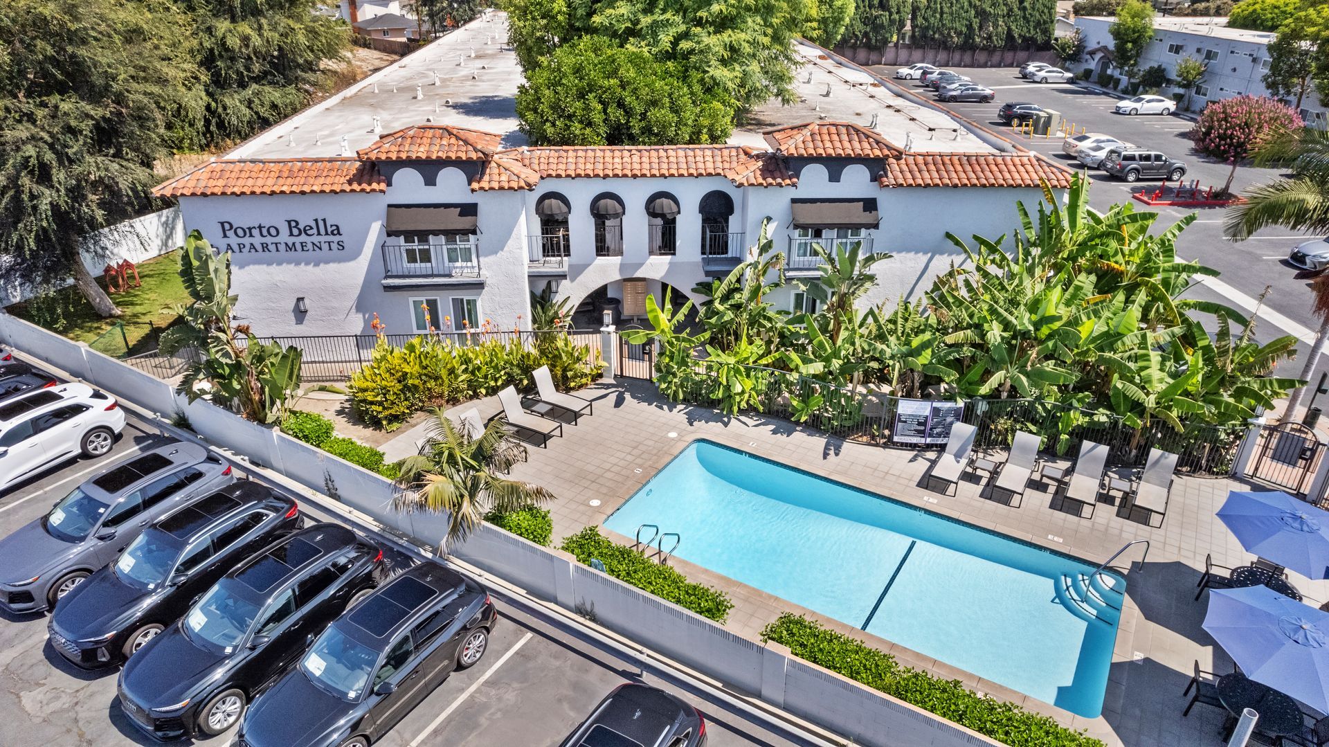 pool and building exterior next to parking lot
