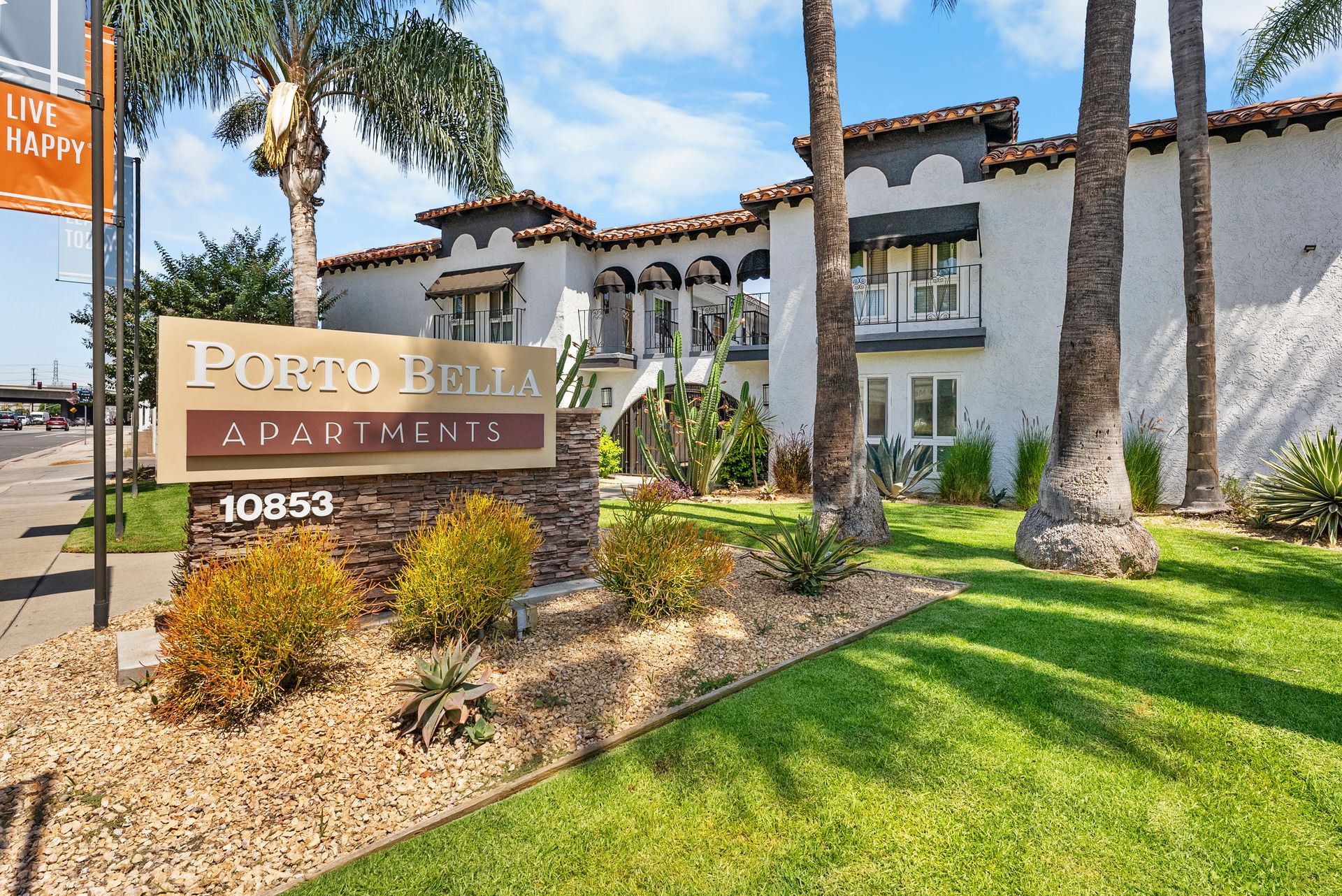 front porto bella apartment sign with building exterior