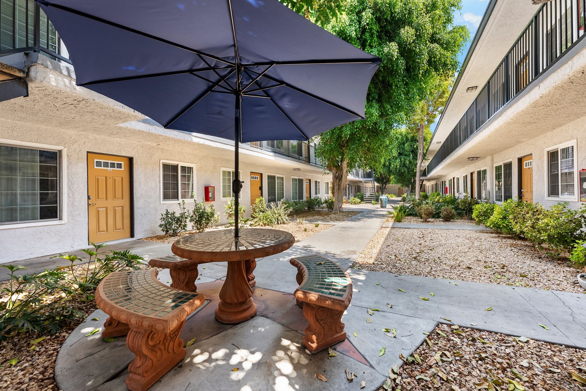 courtyard with picnic table and sun umbrella