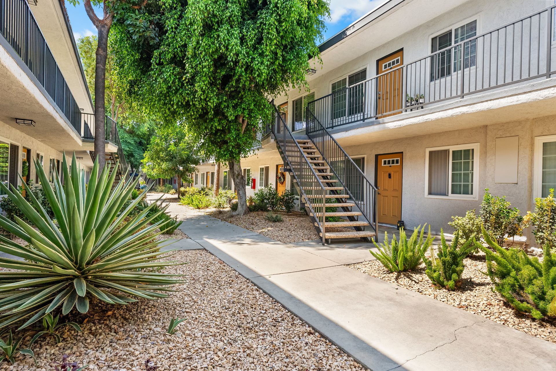 walkway to apartment exterior with stairs