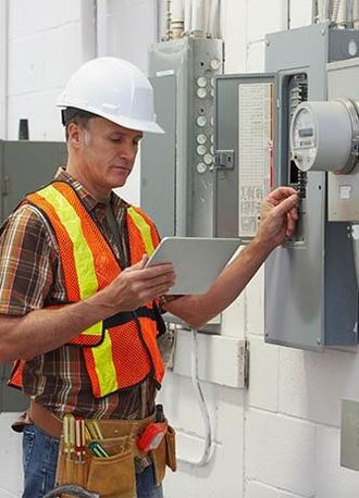 Electrician Checking Electric Cabinet — Electrician in Sebastian, FL
