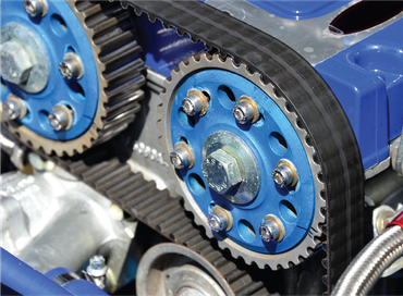 A man is holding a clutch disc in his hands.