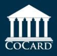 A white building with columns and the word cocard on a blue background.