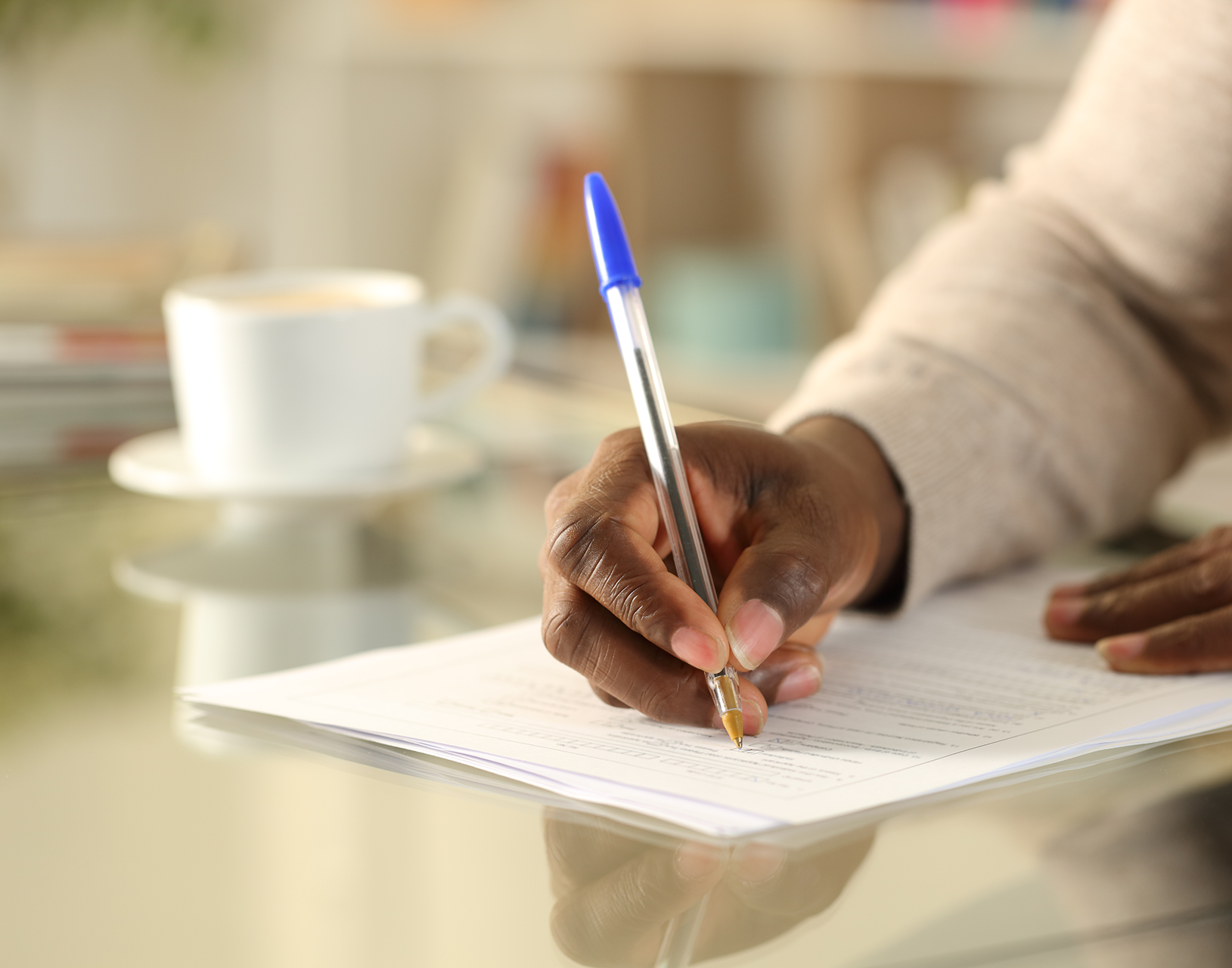 A group of people are standing around a coffin at a funeral.