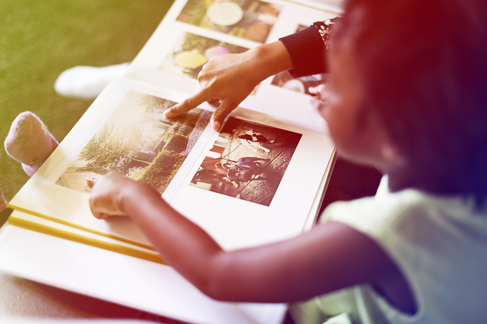 A person is taking a picture of a man and a boy in a photo album.