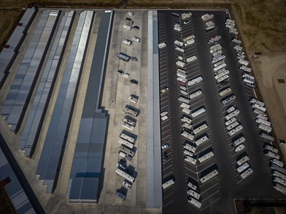 an aerial view of a parking lot full of rvs