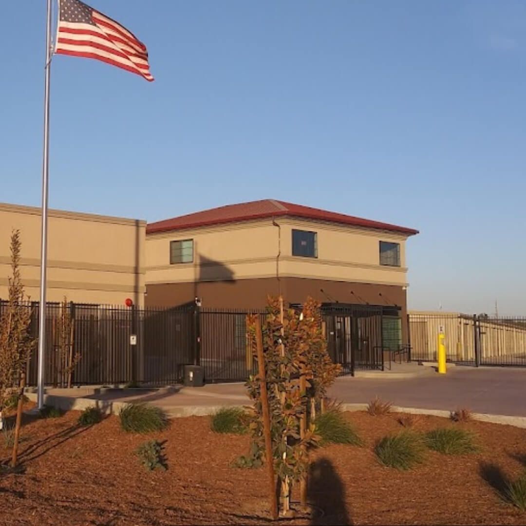 an american flag is flying in front of a building