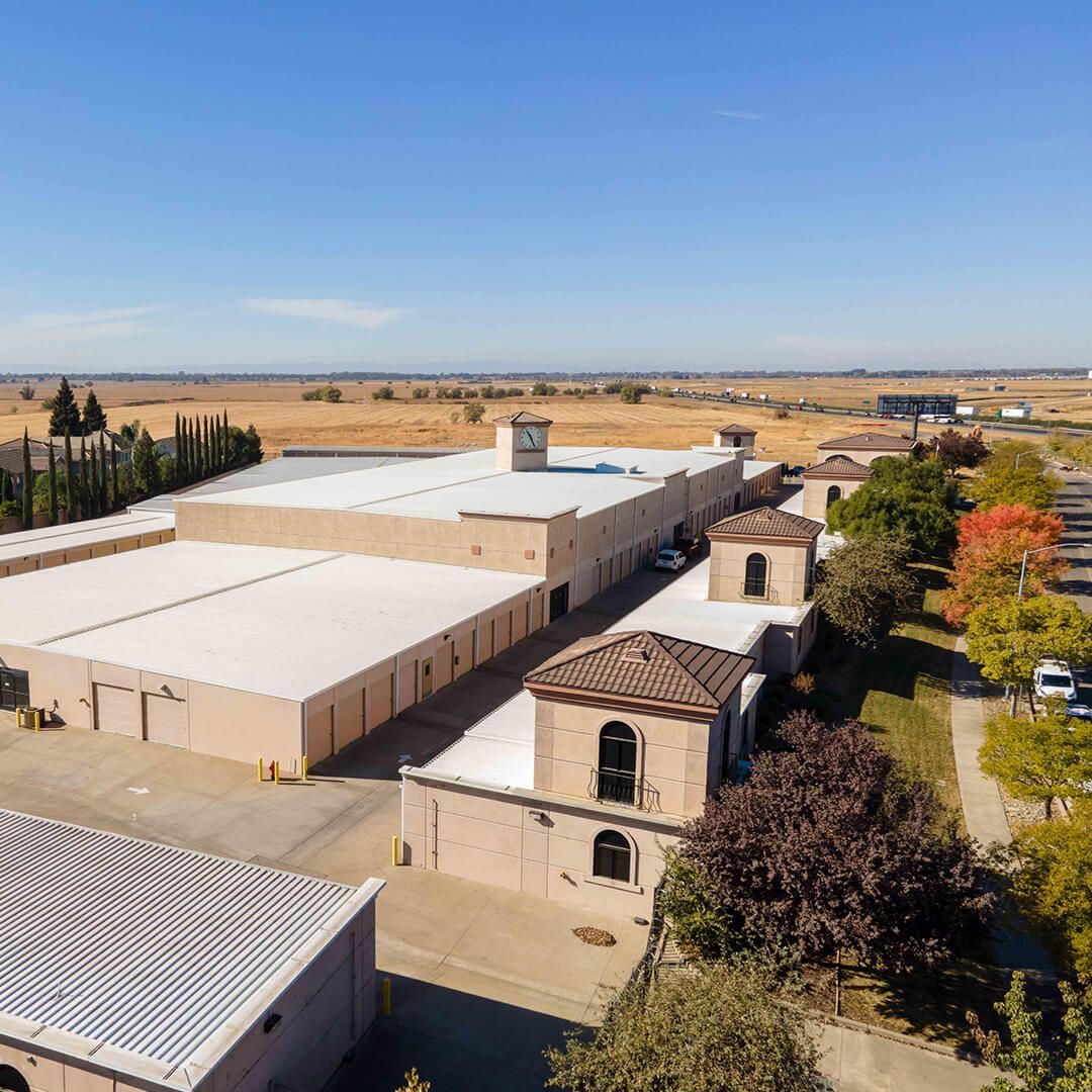 an aerial view of a storage facility with a billboard in the background