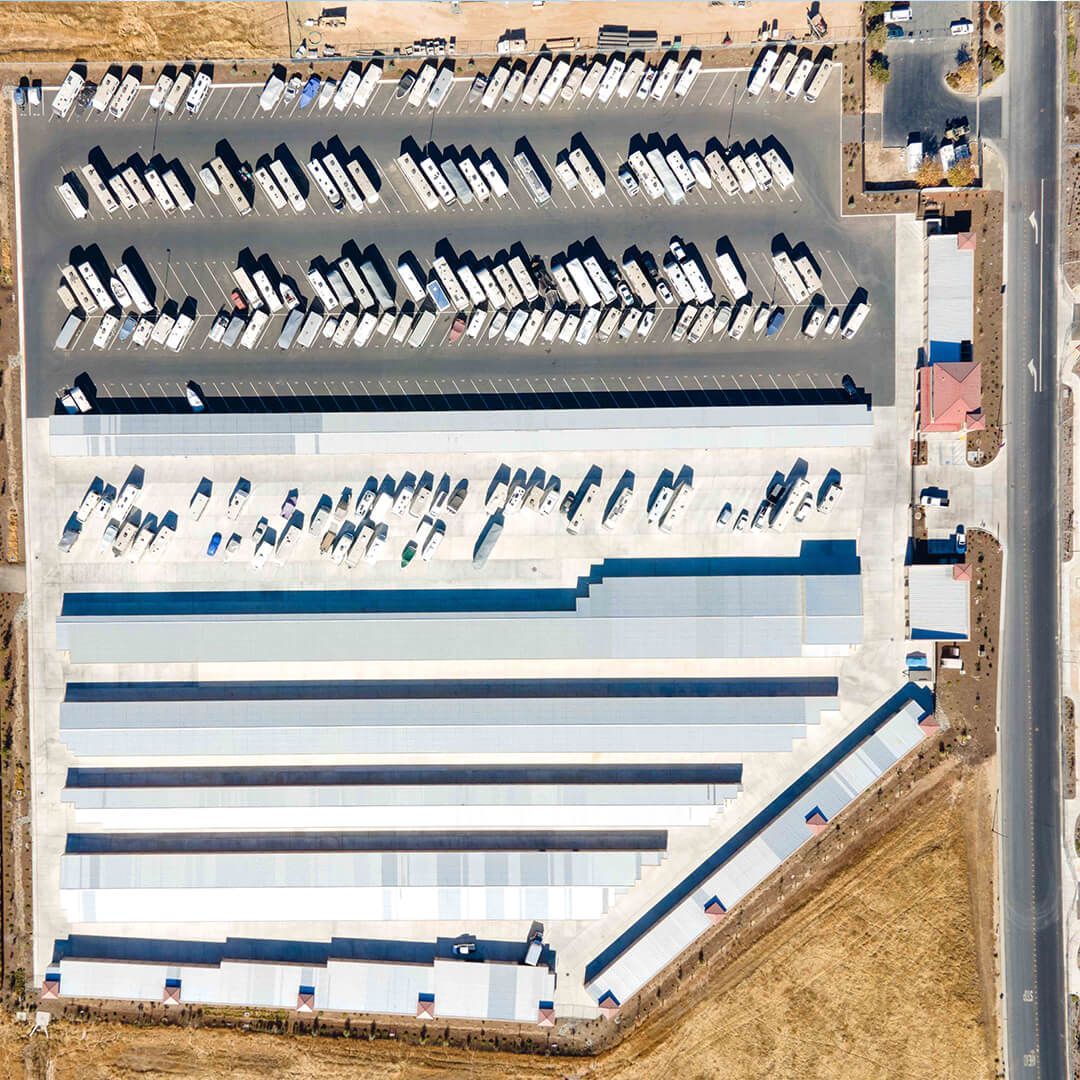 an aerial view of a parking lot filled with trucks