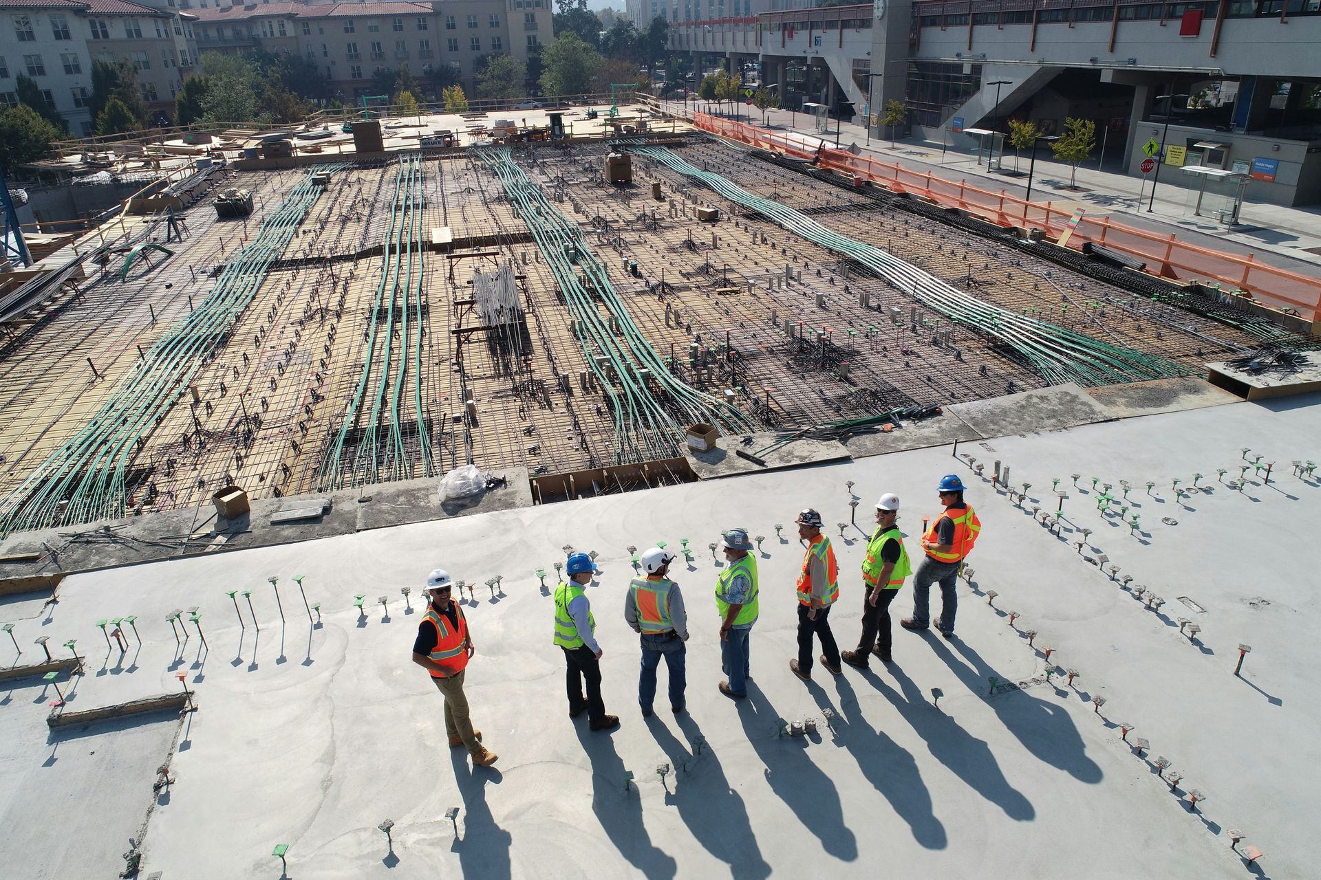 Construction site overseers standing on top of a concrete platform overseeing a construction site 