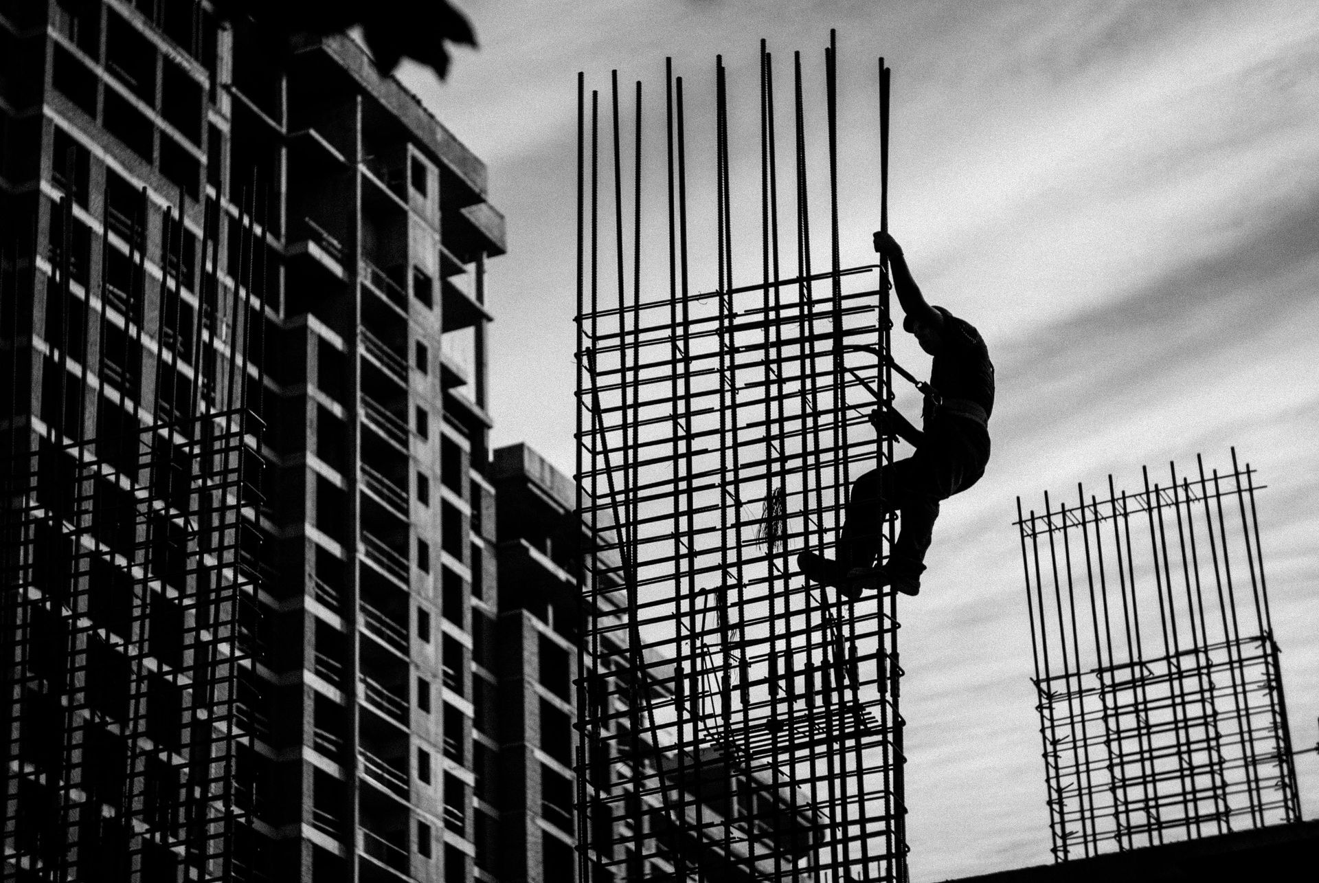 Construction worker silhouetted against cityscape
