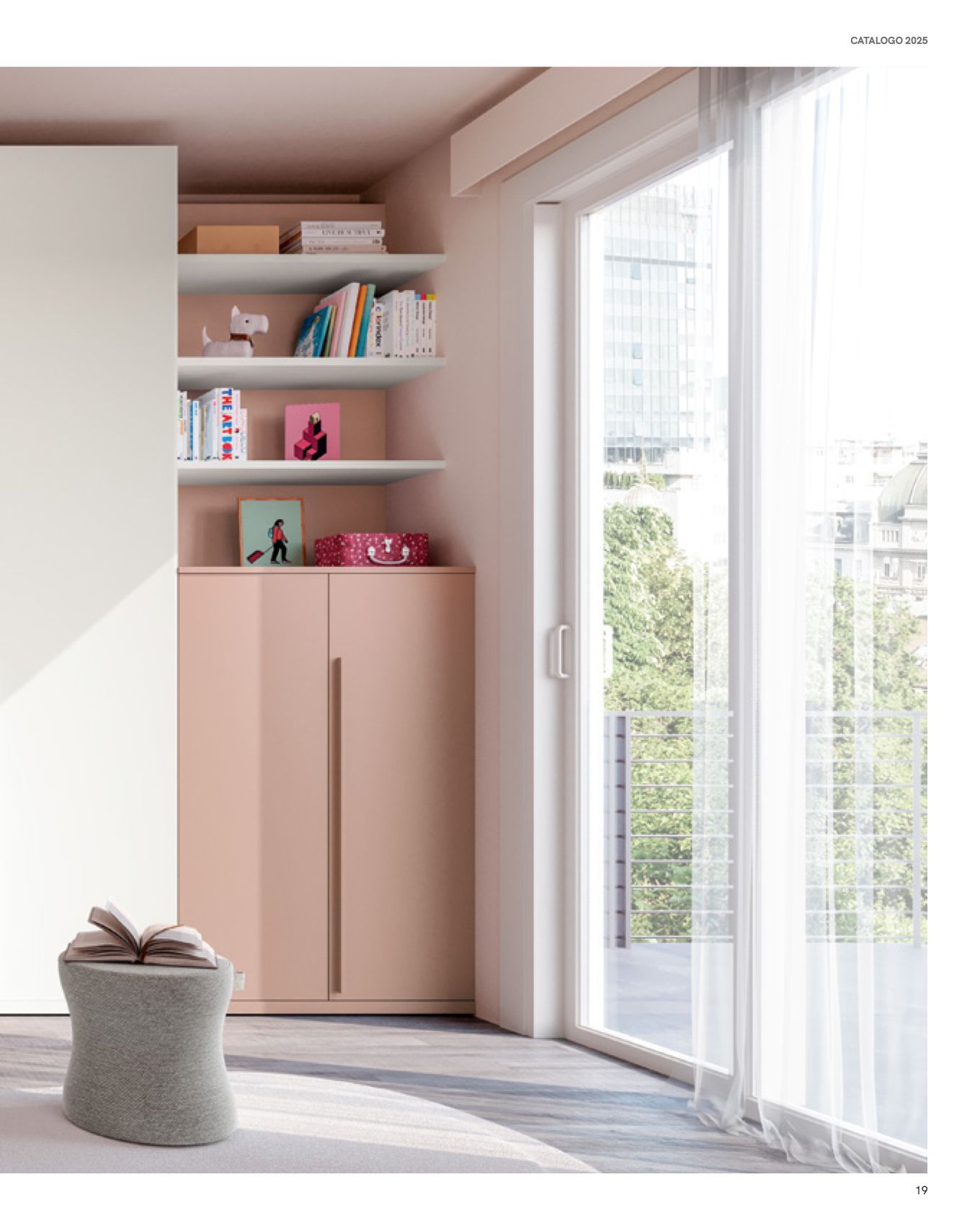 Mobile contenitore rosa con ripiani e mobiletto accanto a una grande finestra con tende trasparenti. 