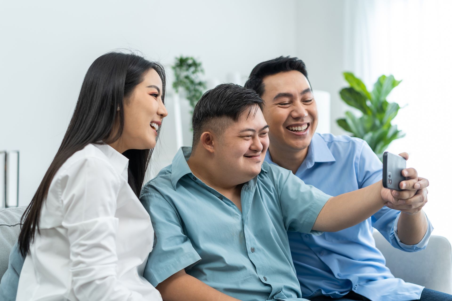 Parents and their young son are using a video call for an online children's continence consultation. Parents and their young son are using a video call for an online children's continence consultation.