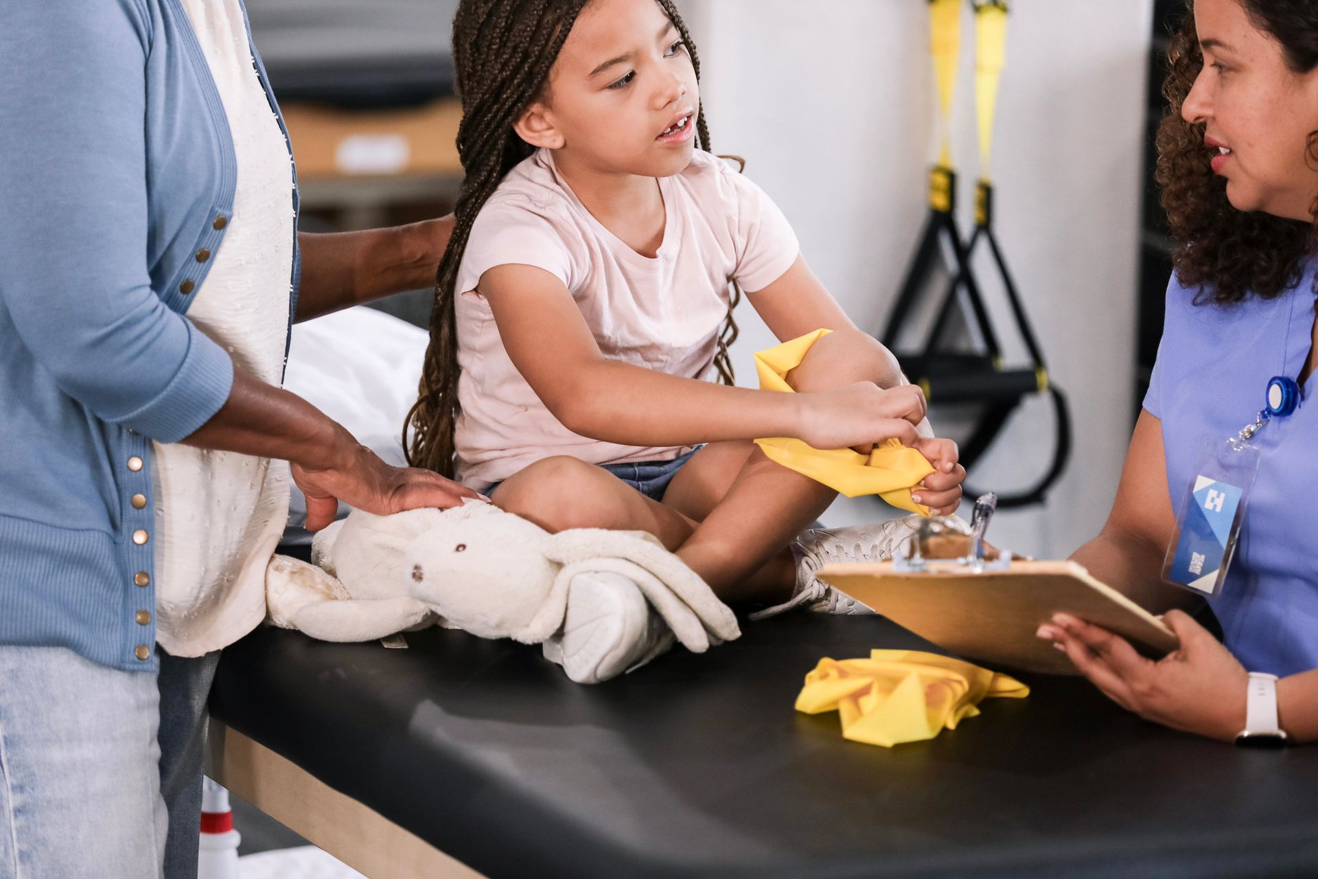 A mother supporting her child during an NDIS continence assessment.