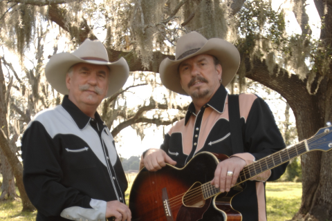 Daniel O'Donnell performs at The Mansion Theatre for the Performing Arts, Branson, MO. Man in blue tuxedo smiles against a blue gradient.