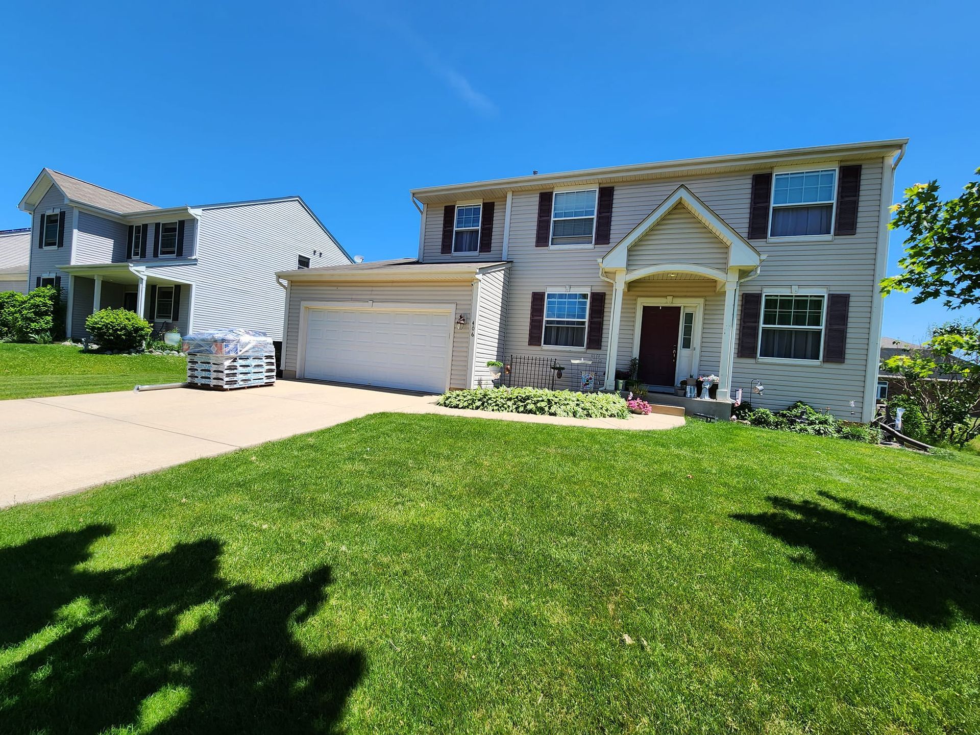 A large house with a large lawn in front of it.