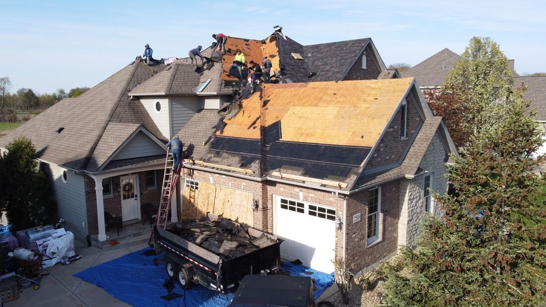 An aerial view of a house undergoing a roof replacement.