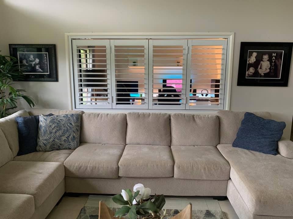 Beige Sectional Sofa in a Living Room, With Shutters on the Window — Innisfail Glass & Aluminium in Innisfail, QLD