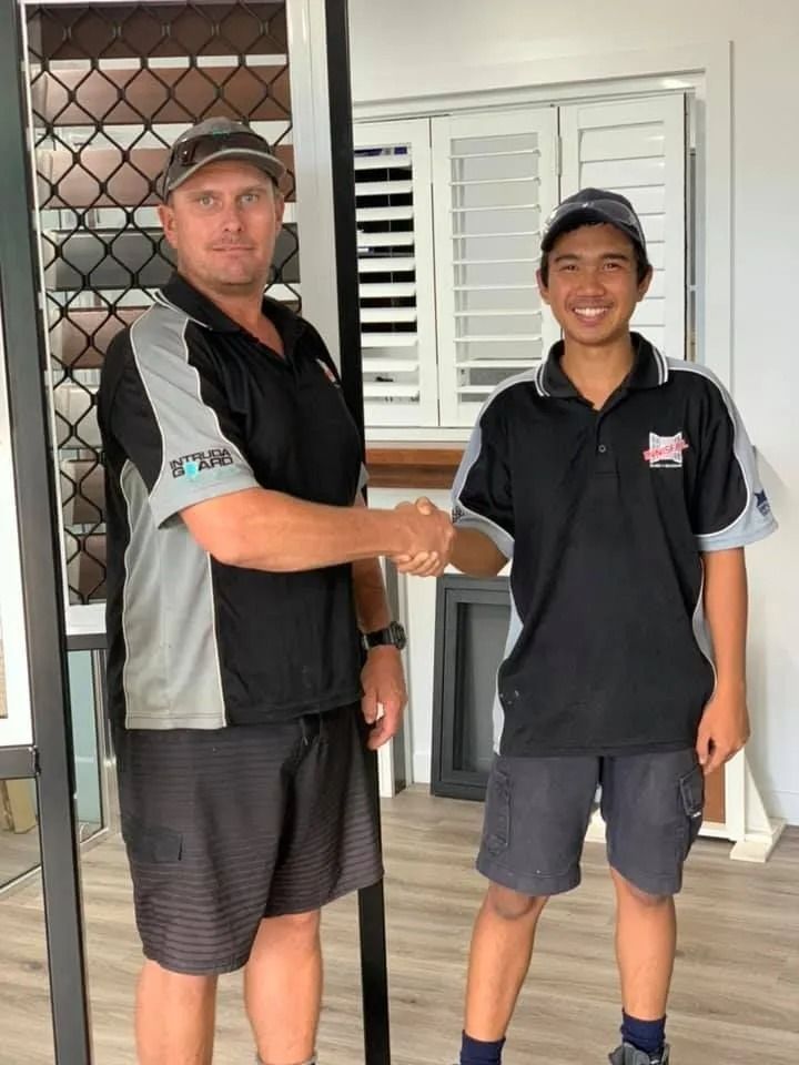 Two Men Shaking Hands in a Showroom — Innisfail Glass & Aluminium in Innisfail, QLD