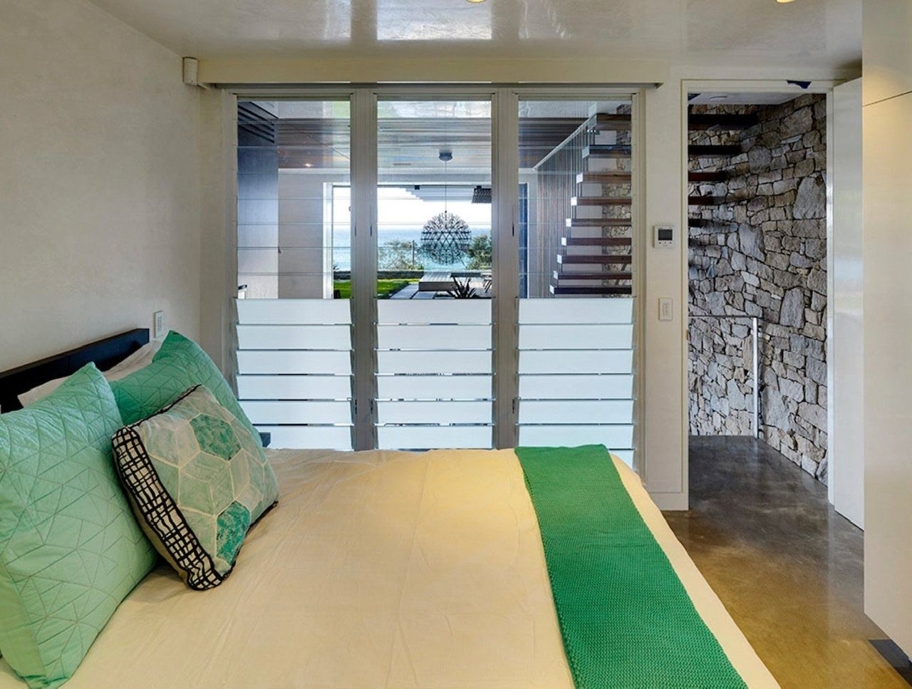 Bedroom With Bed, Teal Pillows and Blanket — Innisfail Glass & Aluminium in Innisfail, QLD