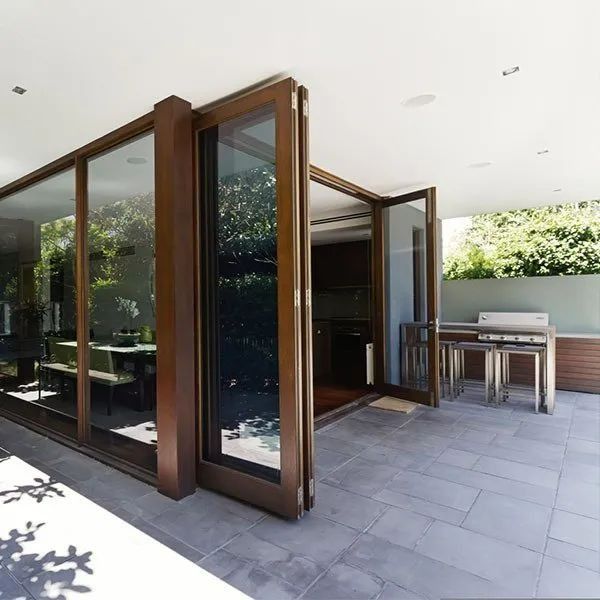 Patio With Large Glass Doors Open to a Kitchen — Innisfail Glass & Aluminium in Innisfail, QLD