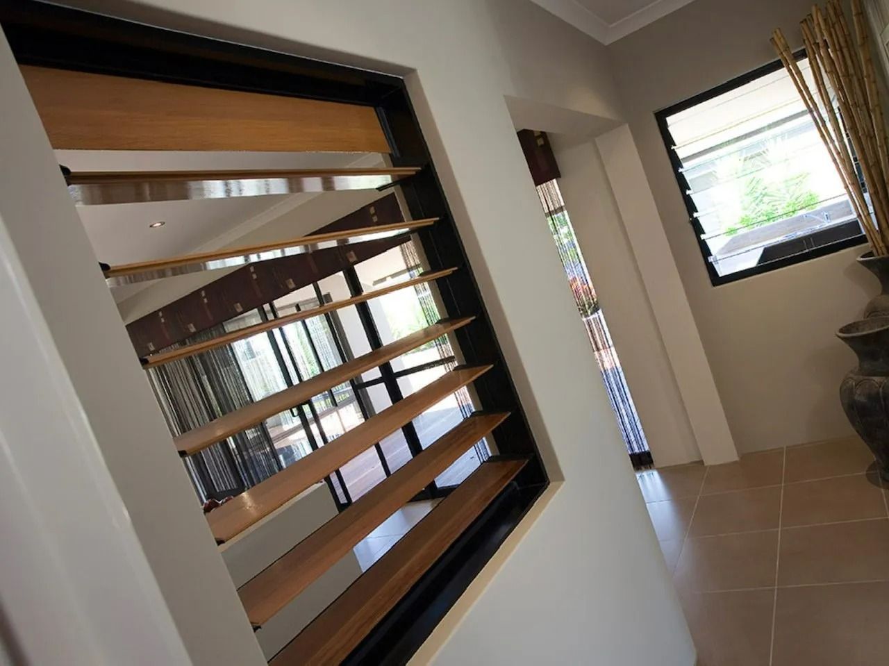 Interior View of a Home With Open Wooden Louvered Window — Innisfail Glass & Aluminium in Innisfail, QLD