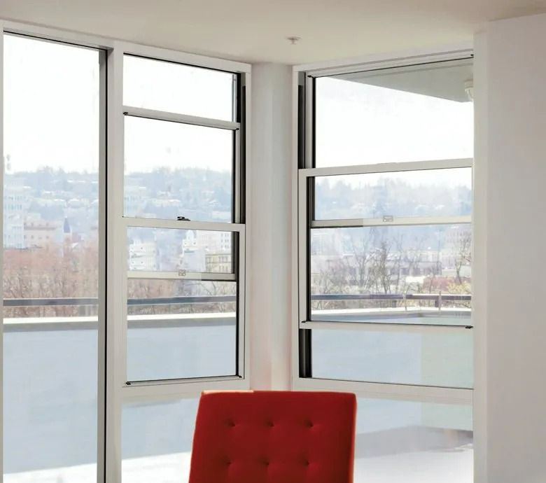 White-framed Double-hung Windows Offer a View of a City — Innisfail Glass & Aluminium in Innisfail, QLD