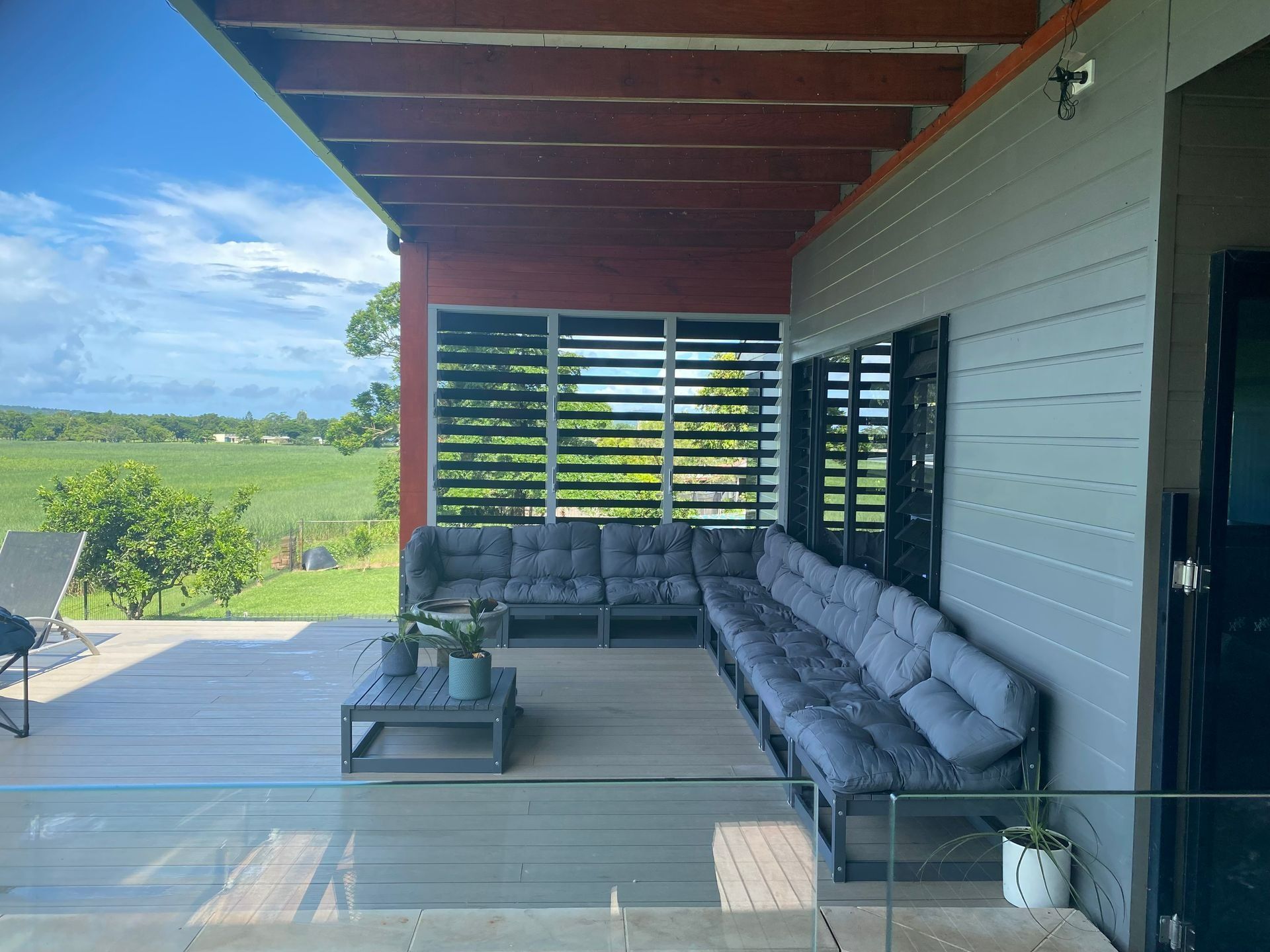 Outdoor Patio With Gray Couches — Innisfail Glass & Aluminium in Innisfail, QLD