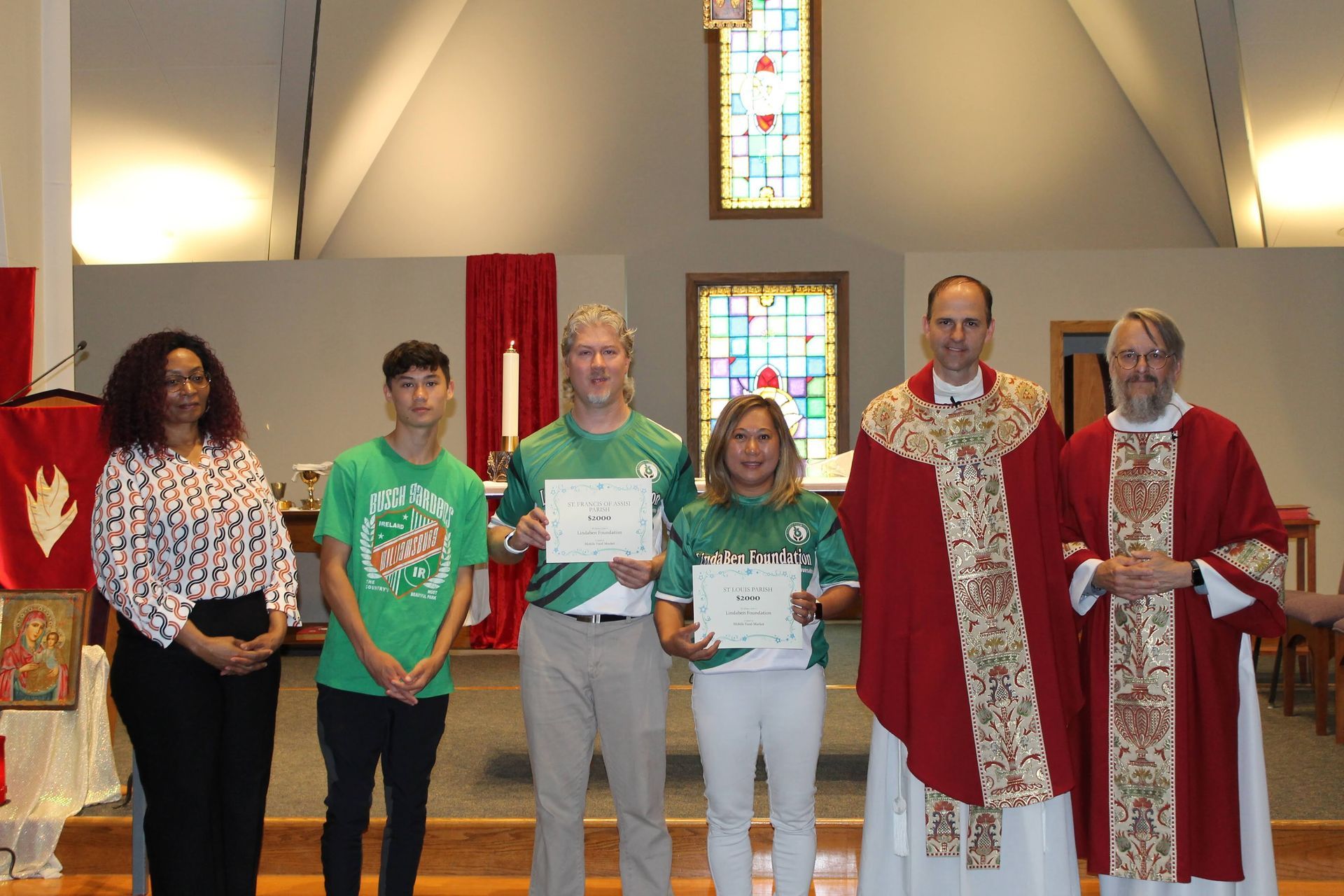 A group of people standing next to each other in a church