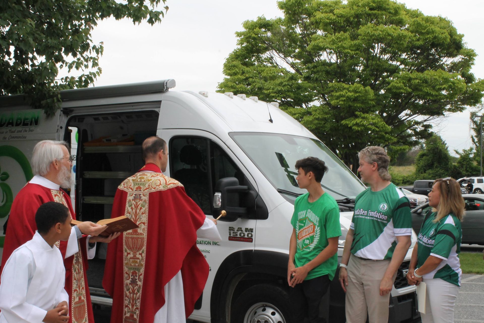 A group of people standing in front of a van that says bosch