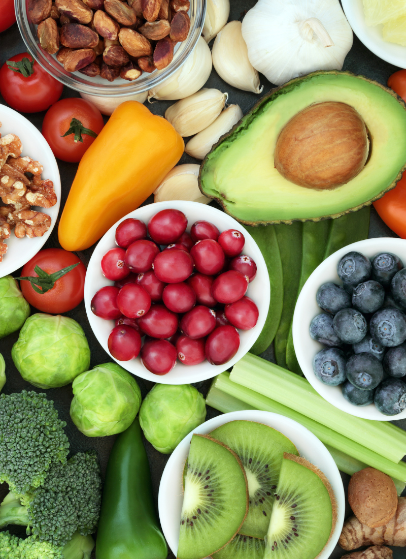 A variety of fruits and vegetables are laid out on a table