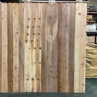 A wooden fence is sitting on the floor in a warehouse.
