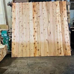 A large piece of wood is sitting on the floor in a warehouse.