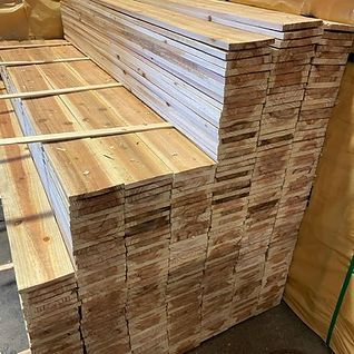 A stack of wooden boards sitting on top of each other in a room.