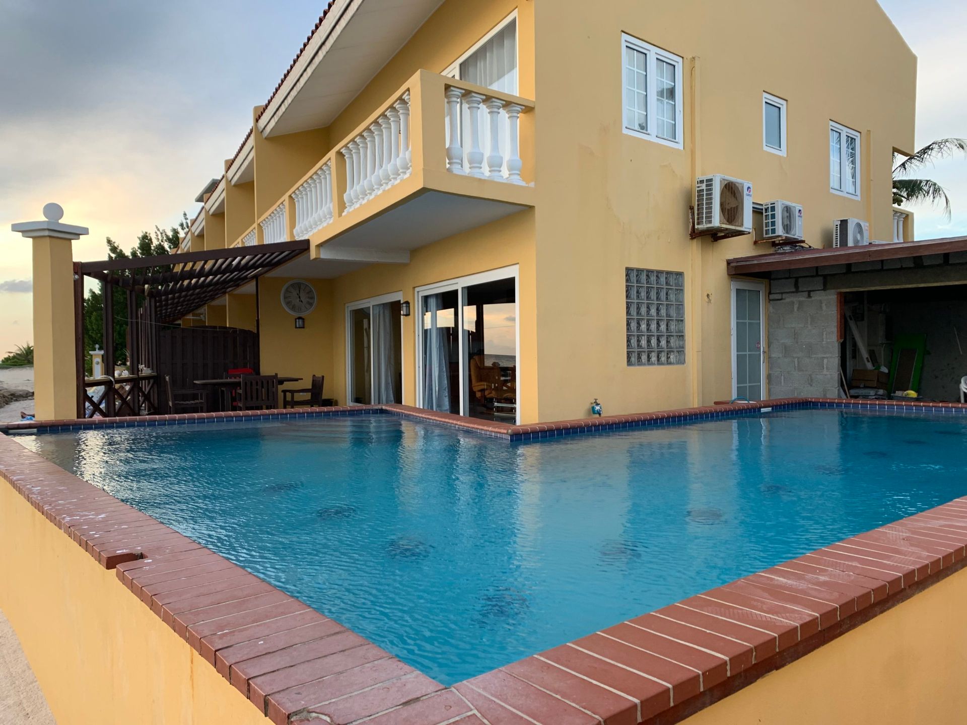 A large house with a large swimming pool in front of it