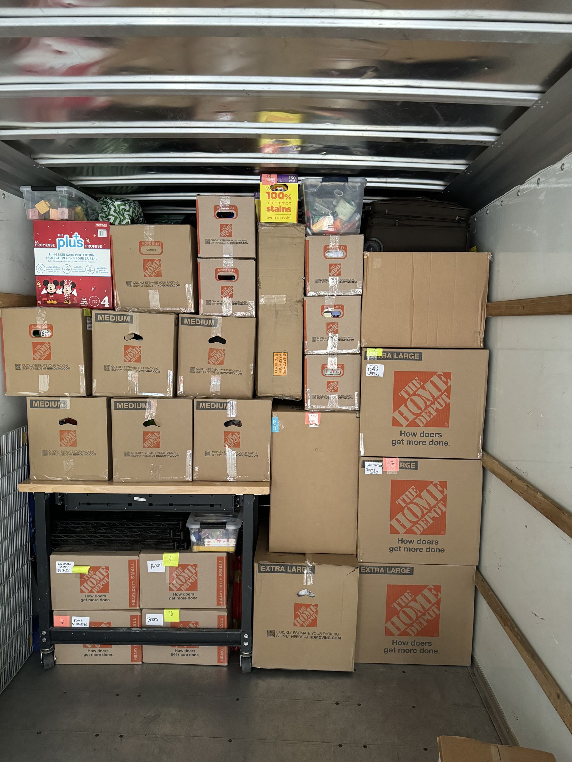 Boxes of various sizes stacked inside a truck, presumably for moving.