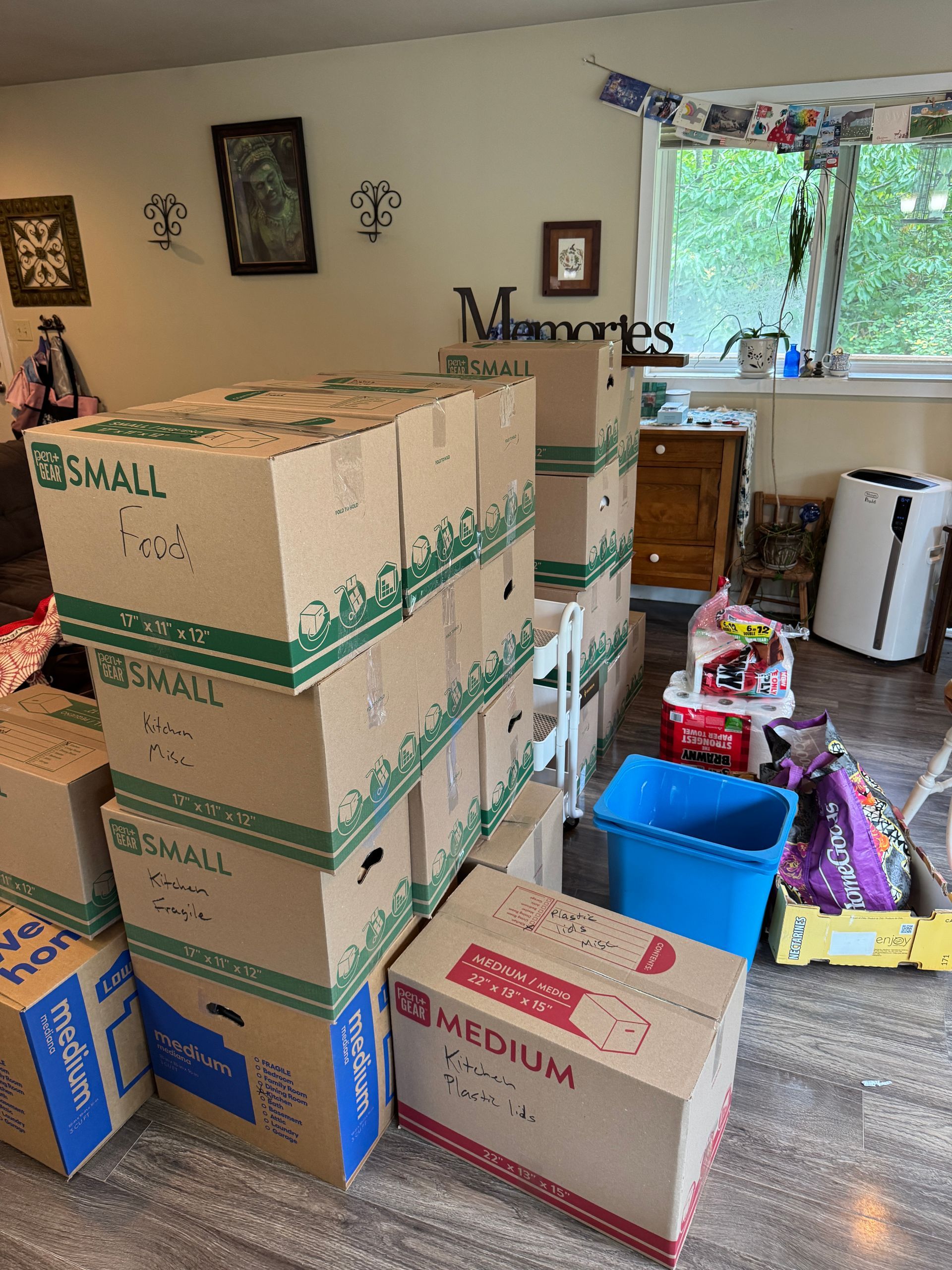Boxes stacked in a room, labeled 