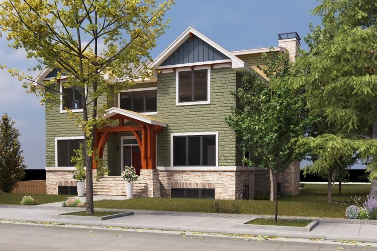 A two-story house with green shingle siding, a stone base, a wooden front porch, and mature trees in a residential setting.