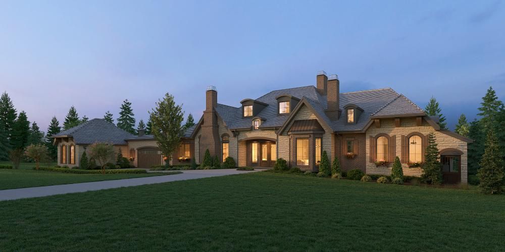 A large, multi-gabled, stone and brick luxury house with a paved driveway, surrounded by trees under a twilight sky.