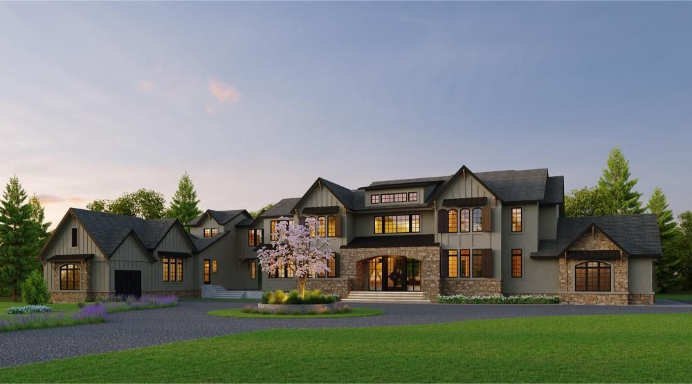 A large, two-story luxury home with stone and wood siding, a grand entryway, and a driveway set against a twilight sky.