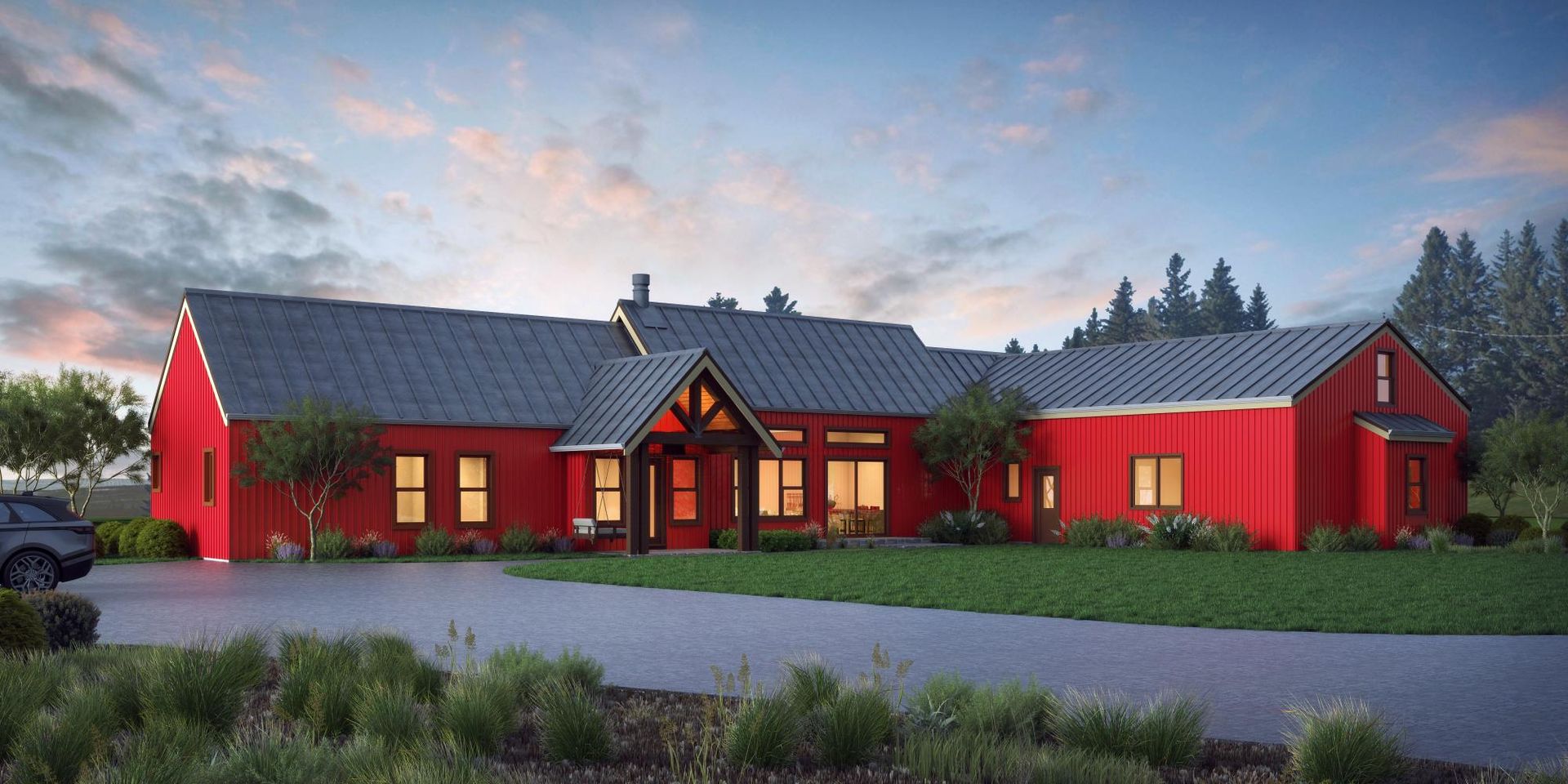 A bright red modern farmhouse with a dark metal roof and wooden entryway stands behind a paved driveway at twilight.