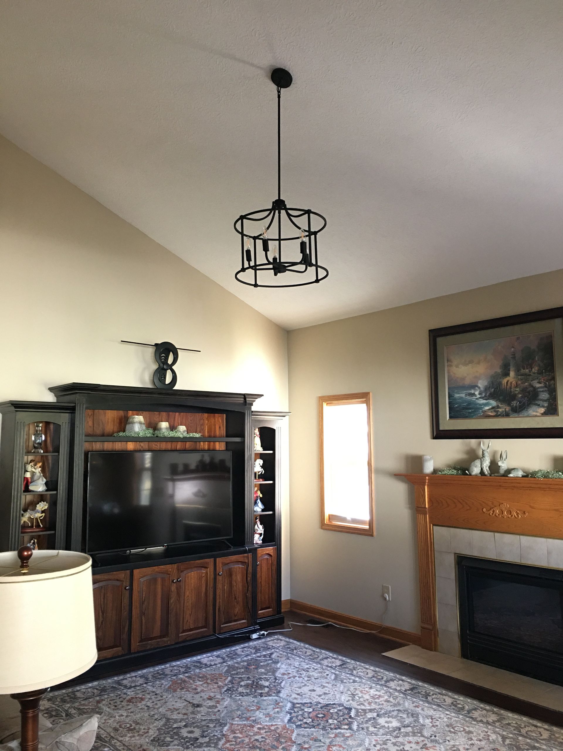 A living room with a fireplace and a television