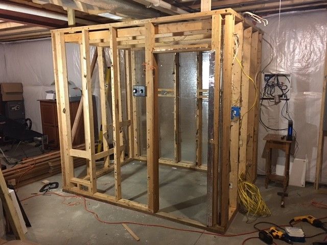 A wooden frame is being built in a basement.