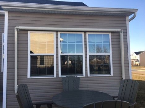 A house with a table and chairs in front of it