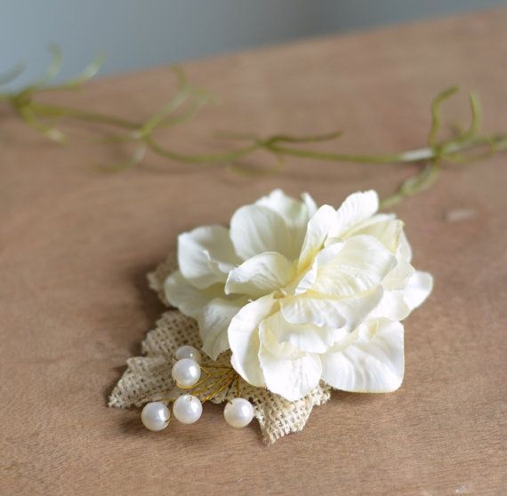 A white flower with pearls on a brown surface