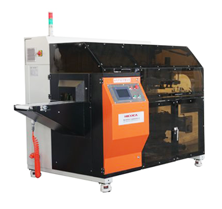 An orange and black machine with a warning light on top of it.