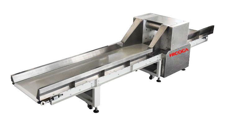 A stainless steel conveyor belt is attached to a machine.